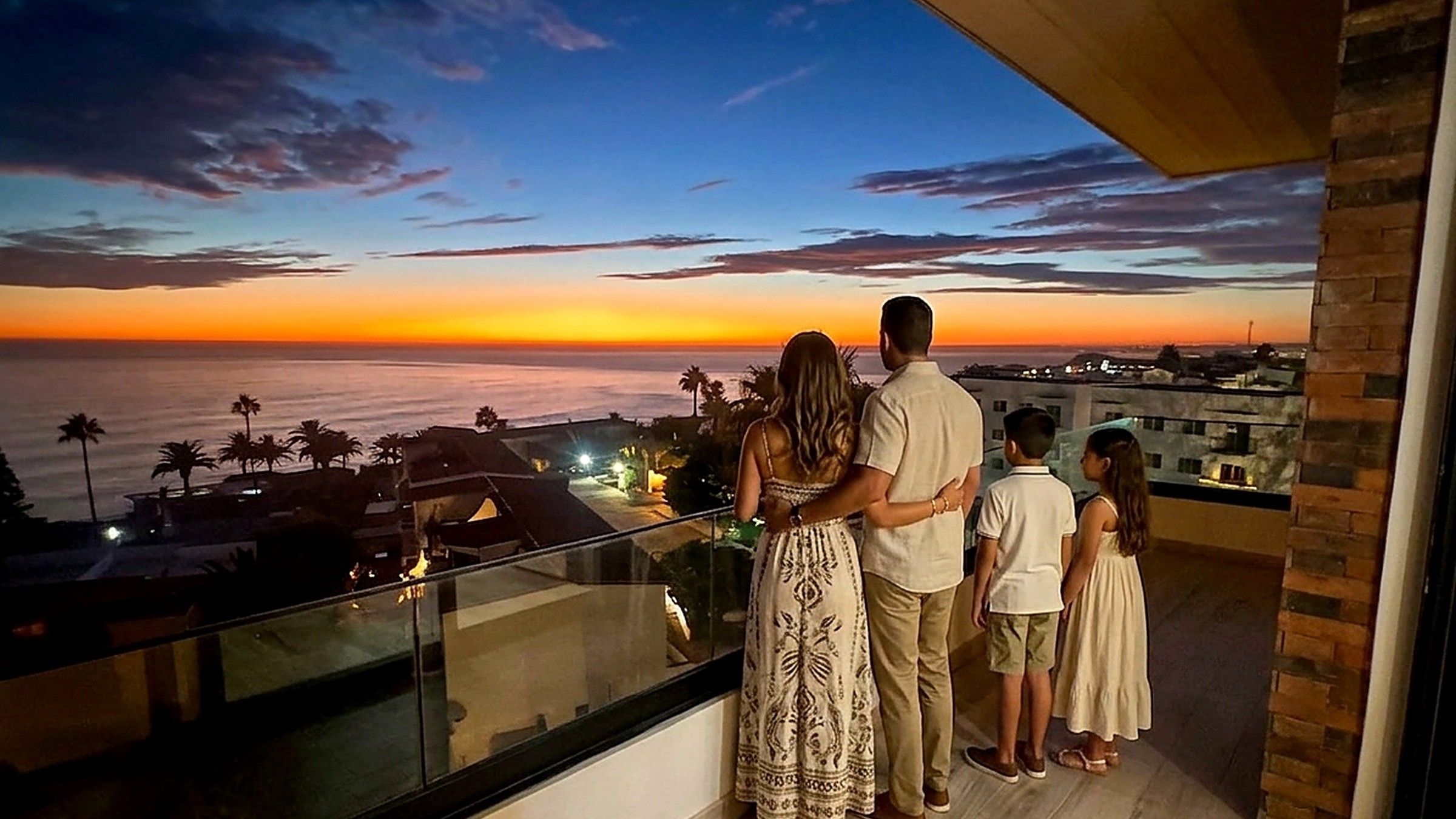 Family taking in the sunset from the private balcony at Baja Penthouse